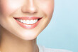 © ARVD73 - Woman smile.Correct healthy care of white teeth with clean skin and make-up, beautiful female face,pure beauty,light blue background.Dental care and health.