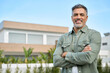 © insta_photos - Happy mature older Latin man new property buyer modern villa owner or realtor salesman standing outside home, smiling middle aged homeowner posing outdoor near country house. Portrait.
