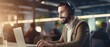 © Onchira - Smiling contract service telemarketing operator using laptop having conversation. Happy call center man agent wearing headset talking to client working in customer support office