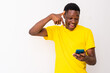 © Confidence - excited young black man checking his smartphone