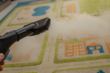 Wall Mural - cleaning carpet in children's room with steam