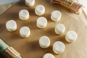 Pristine Mounds: A Flourish of White Dough Effortlessly Resides on a Polished Table