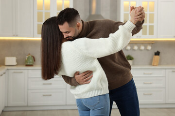 Canvas Print - Affectionate young couple dancing in light kitchen