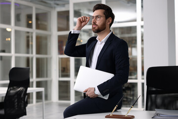 Wall Mural - Portrait of handsome man with laptop in office. Lawyer, businessman, accountant or manager