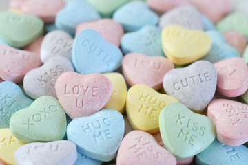 Wall Mural - Pastel candy conversation hearts background for Valentine's Day - love u, kiss, hug, XOXO, cutie