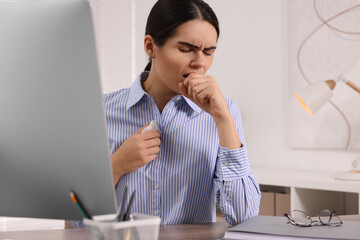 Poster - Woman with tissue coughing at table in office. Cold symptoms