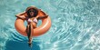 Woman laying in an innertube pool floatie on the pool water surface during spring break and summer vacation