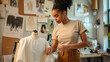 © MP Studio - young woman is adjusting a garment on a mannequin in a well-organized fashion design studio