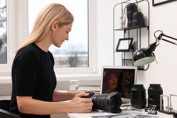 Canvas Print - Professional photographer with digital camera at table in office