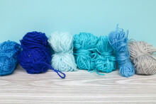 Bright Blue Yarn Isolated On Blue Background. Collection Of Blue Yarn On The Table