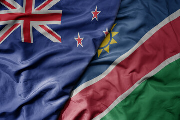 Wall Mural - big waving national colorful flag of namibia and national flag of new zealand .