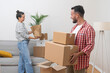 © olga_demina - Positive couple of man and woman pack boxes with things getting ready to move to new place and start exciting new life together filled with joy and anticipation