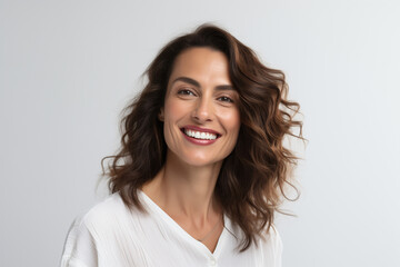 Poster - A photo portrait of a beautiful turkish woman over 30 years old, smiling with clean teeth, perfect teeth. To advertise dentistry, white background