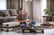 © shintartanya - Travel,woman packing luggage in suitcase and planning solo trip eco friendly,travel banner and packing suitcase.