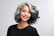 © Anastasiya - Portrait of a happy mature asian woman on a gray background. Facial skin care concept, anti-aging cosmetics, cosmetology