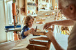 © Marko Geber - Grandfather and grandson building a wooden model in a workshop