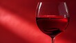 © Елена Григорова - Glass of red wine with a deep red background and light reflections. Application: Beverage marketing, wine tasting events, romantic dining