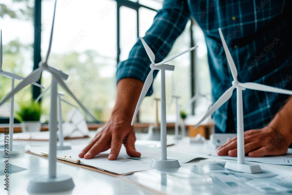 Engineer designing project with renewable energies in the office, wind ...