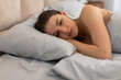 © Prostock-studio - Depressed young woman lying in bed, looking troubled