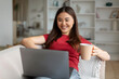 © Prostock-studio - Weekend Pastime. Beautiful Asian Woman Using Laptop And Drinking Tea At Home