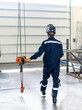 © Vadim - Worker in special uniform carries out maintenance work on crane