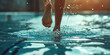 © SnowElf - Underwater closeup view of female Feet. Legs of a synchronized swimmer woman against the serene backdrop of a swimming pool.