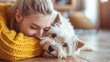 Kind female person and faithful small terrier snuggling to each other with heads while staying on wooden floor at home. Affectionate woman and cuddly Westie enjoying bonding interaction on sunny