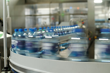 Aufkleber - Part of moving production line with capped plastic bottles containing mineral water or some other drink in large modern factory