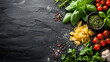 Food photography of healthy raw Italian ingredients, including pasta and fresh tomatoes, on a black slate background with copy space.