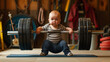 Infant in a squat position holding a barbell. Great for fitness inspiration content and parenting magazines