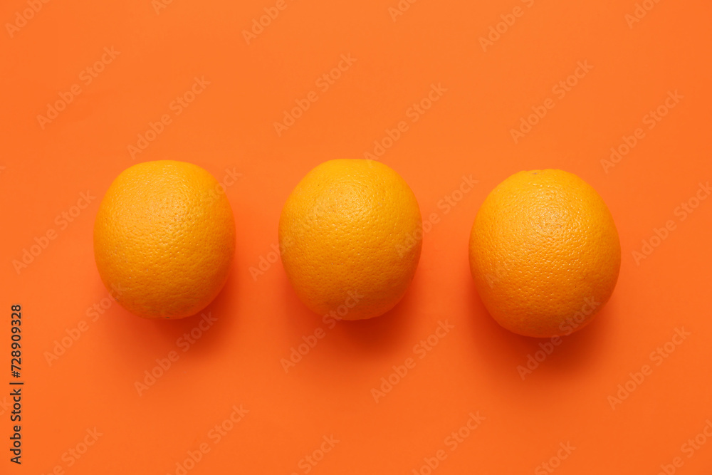 Tasty ripe oranges on color background