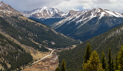 Wall Mural - Spring Mountains - Panoramic view of Highway 82 winding in Lake Creek Valley, with snow-capped La Plata Peak (14,336 ft) of Sawatch Range towering in background, as seen from Independence Pass. CO, US