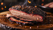 A thick slice of slowsmoked brisket its deep savory flavor complemented by a sweet and y BBQ glaze. The charred edges and pink smoke ring are a testament to the hours spent
