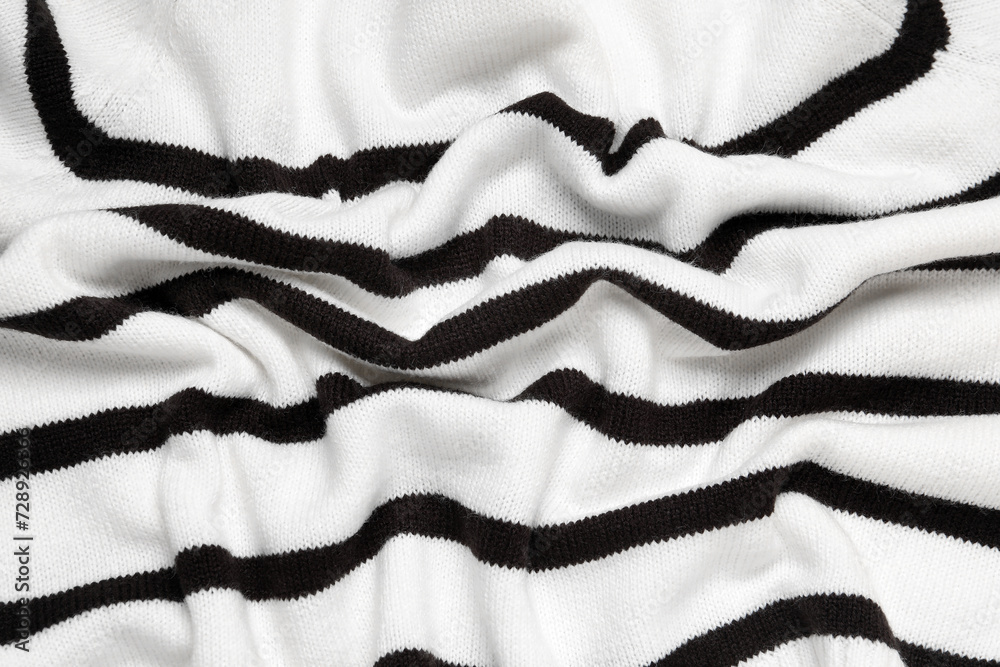 Texture of stylish knitted fabric with folds as background