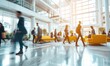 © bagoesanggito - Bright business workplace with people in walking in blurred motion in modern office space