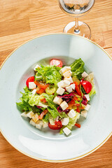 Wall Mural - greek salad on the wooden background