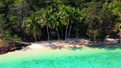 Wall Mural - Koh Wai Island Trat Thailand is a tinny tropical Island near Koh Chang. wooden bamboo hut bungalow on the beach. a young couple of men and woman on a tropical Island in Thailand