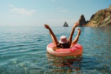 summer vacation woman in hat floats on an inflatable donut mattress. happy woman relaxing and enjoyi