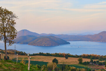 Wall Mural - Scenic view of sea and mountains against sky