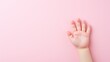 Pink background highlights a child's hand, conveying the significance of children's health.