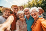 Fototapeta Londyn - Happy group of senior people smiling at camera outdoors - Older friends taking selfie pic with smart mobile phone device - Life style concept with pensioners having fun together on summer,GenerativeAI