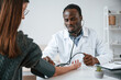 © standret - A doctor measures a young woman's blood pressure