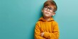© ckybe - Contemplative young boy wearing spectacles on vibrant backdrop.