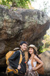 © Natee Meepian - Lovely couple lesbian woman with backpack hiking in nature. Loving LGBT romantic moment in mountains