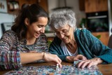 Fototapeta  - Smiling female caregiver assisting senior woman doing puzzle at home