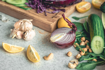 Close-up, half an onion on a kitchen table with fresh vegetables for salad.