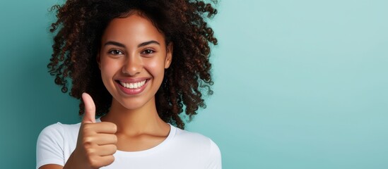 Poster - Confident curly woman in a white t-shirt, happy and giving a thumbs up symbol, enjoying a nice day.