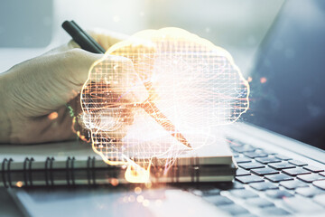 Poster - Double exposure of creative artificial Intelligence symbol with hand writing in notebook on background with laptop. Neural networks and machine learning concept