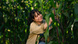 © Prathankarnpap - Beautiful young female farmer checking the quality of corns plants at organic field
