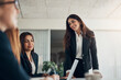 © Flamingo Images - Smiling manager talking with her team during a boardroom meeting together